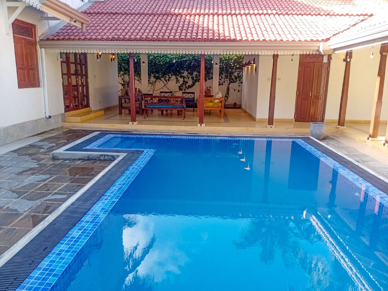 The private pool and terracotta-roofed veranda at Thalpe Serenity Shore