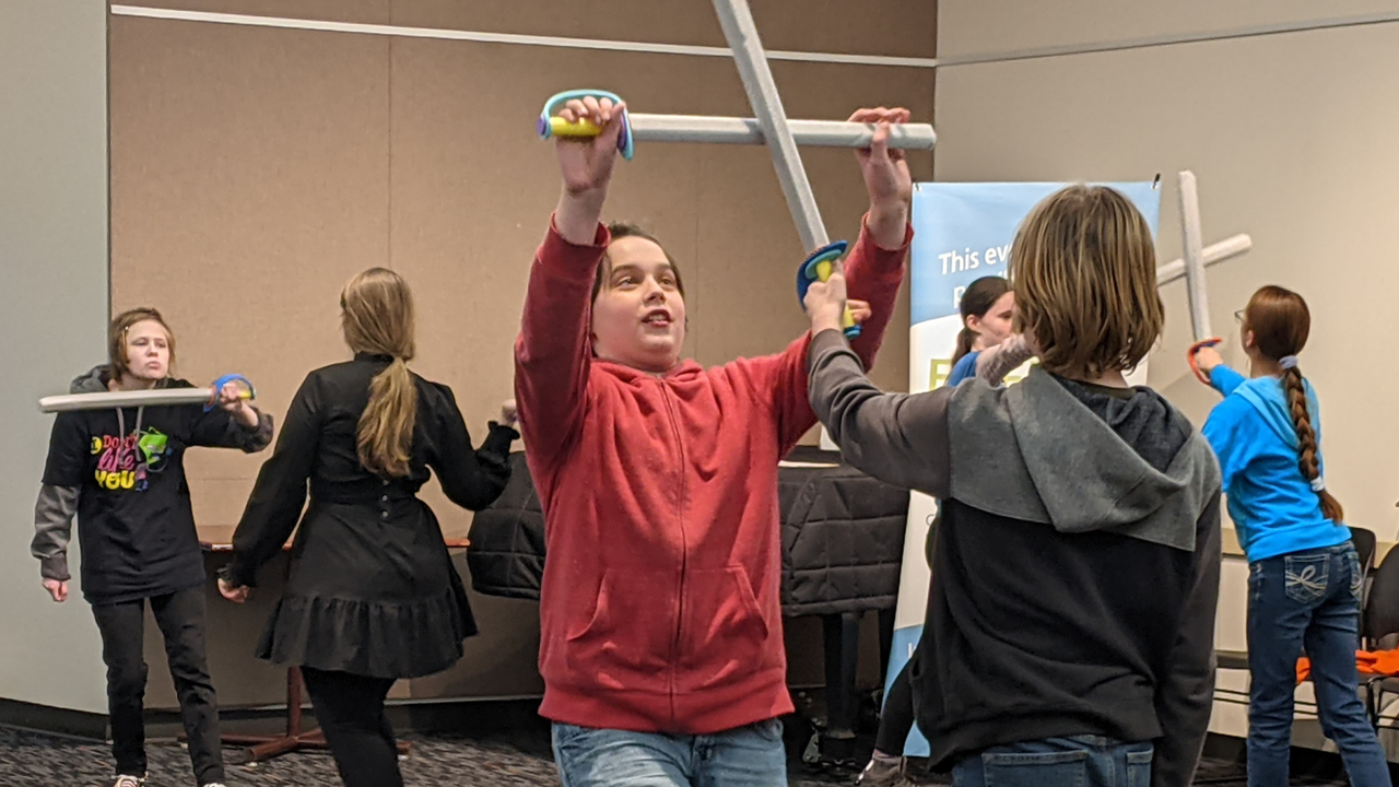Four children in costumes on a stage