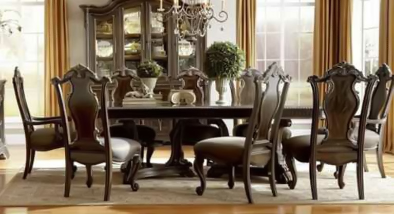 Drawing inspiration from the finest Italian art and architecture, the Gables Dining Room Collection by ART Furniture grandly imagines' the splendor of the Great Masters. Generously scaled with hand-selected crotch oakum, mahogany, and primavera veneers, it is a visual feast made all the more alluring with a rich, hand-polished, Blackened Sorrel finish. Exquisite carvings are subtly gilt with broken leaf edges, striking in their refinement, a harmonious blend of ornament and drama. Fine marble and forged iron elements lend a natural texture, while elegant upholstered details soften the milieu, a show of rare and delicate balance. Come home to the Gables collection, where gracious living really is in the details.