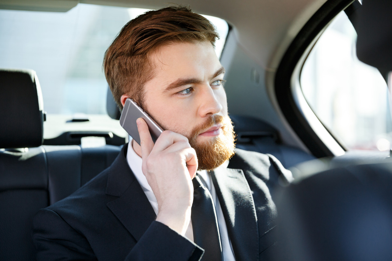 portrait concentrated business man talking mobile phone