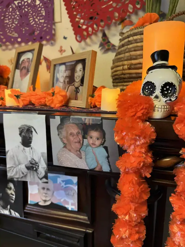 a communal ofrenda with a photo of my great grandmother holding baby me on it.