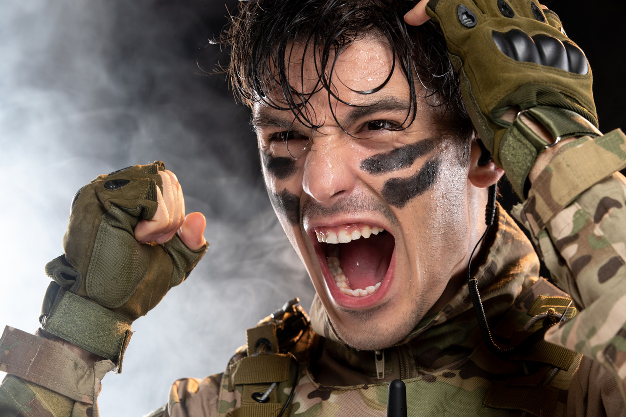 portrait screaming young soldier camouflage dark wall