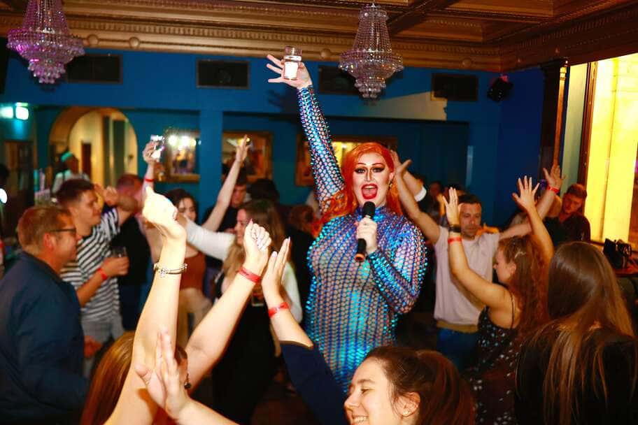 Drag queen singing in a fancy dress
