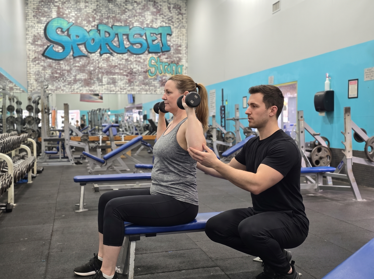 A Sportset personal trainer coaching a client through a workout