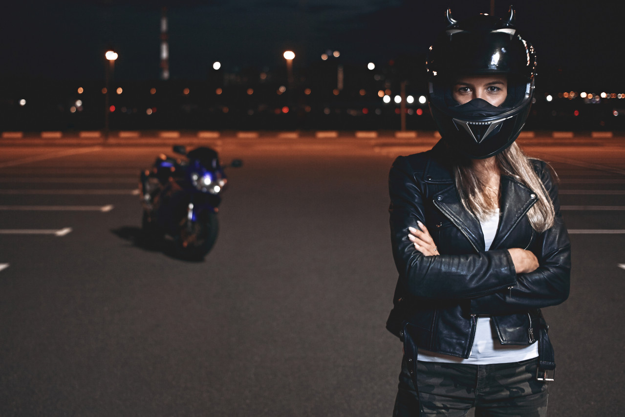 picture confident self determined young female rider safety helmet standing parking lot keeping arms