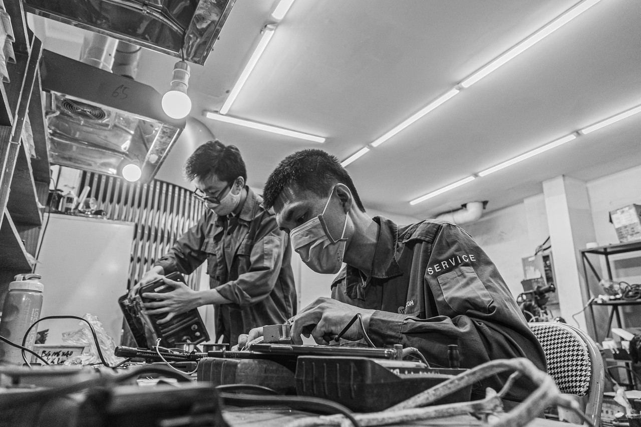 Close-up of a hand connecting wires in an electrical box.
