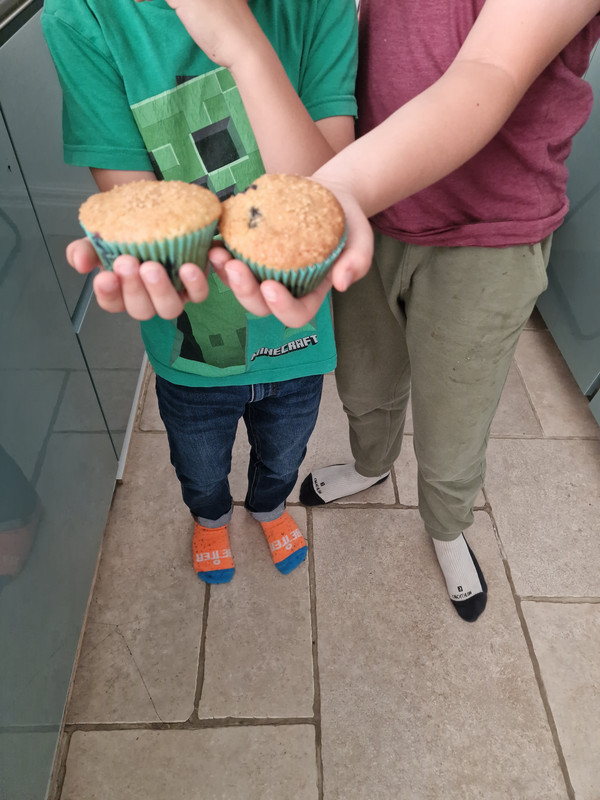Magnus and Roscoe proudly holding their homemade muffins