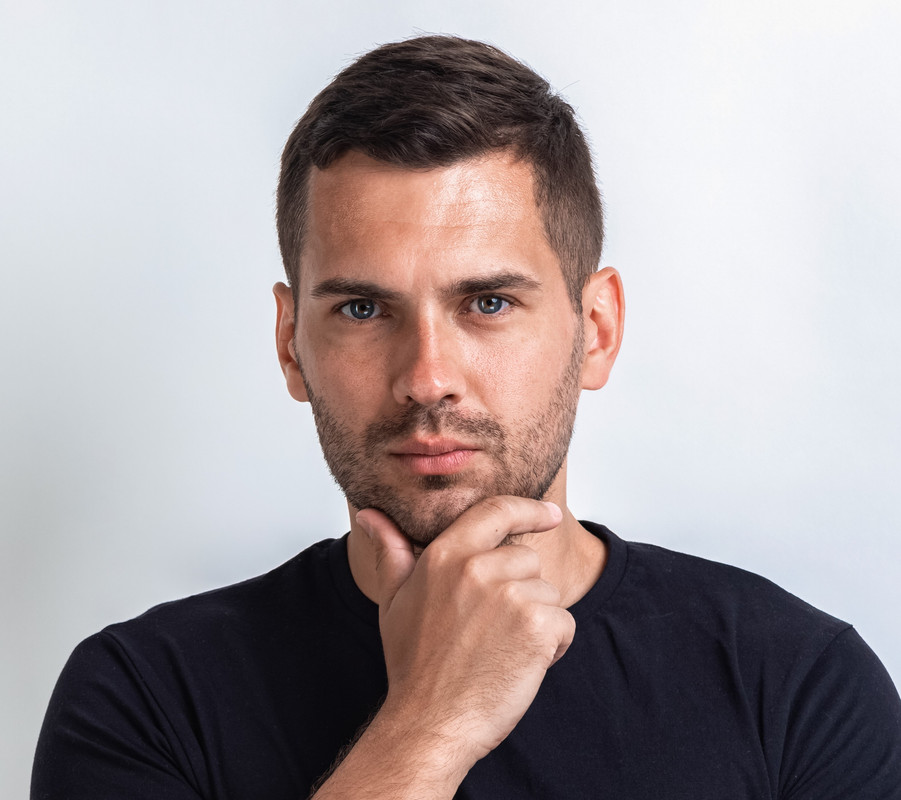 vecteezy-portrait-of-serious-man-folded-hands-and-touches-one-hand-his-chin-image-3492369.jpg