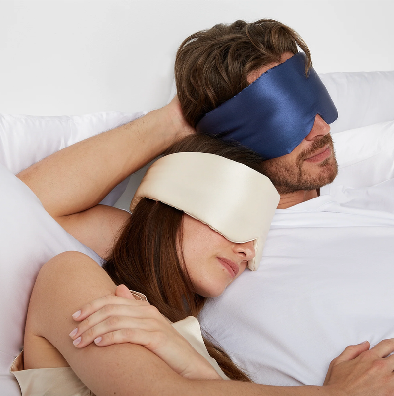 Couple wearing silk sleep masks in bed