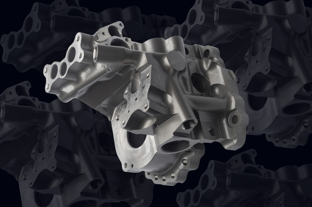 CNC metal product photography with dramatic lighting for manufacturing marketing