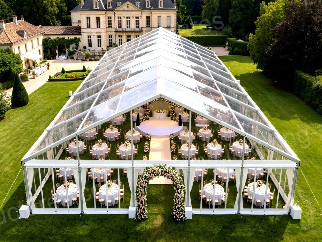 Romantic wedding tent with flower arrangements and aisle decoration