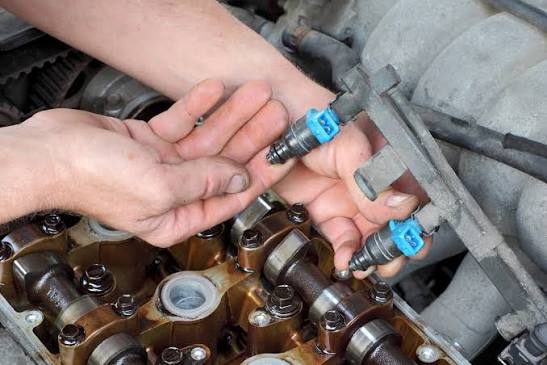 Fuel injectors removed from car engine