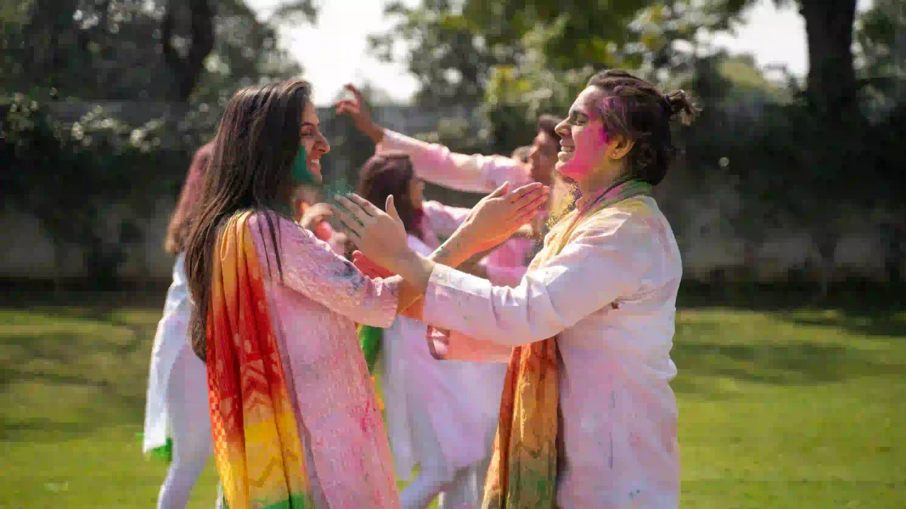 Couples applying colors in lawn area Pushkar Holi