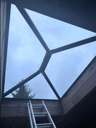 Glass roof installation after - completed aluminium-framed lantern roof viewed from below showing sky through glazed panels