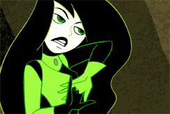 Animated GIF of Shego cracking her knuckles, activating her powers, lunging at an offscreen enemy, and letting off an energy blast from her glowing hands.