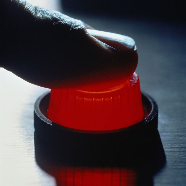 Finger-pushing-red-button-close-up.jpg