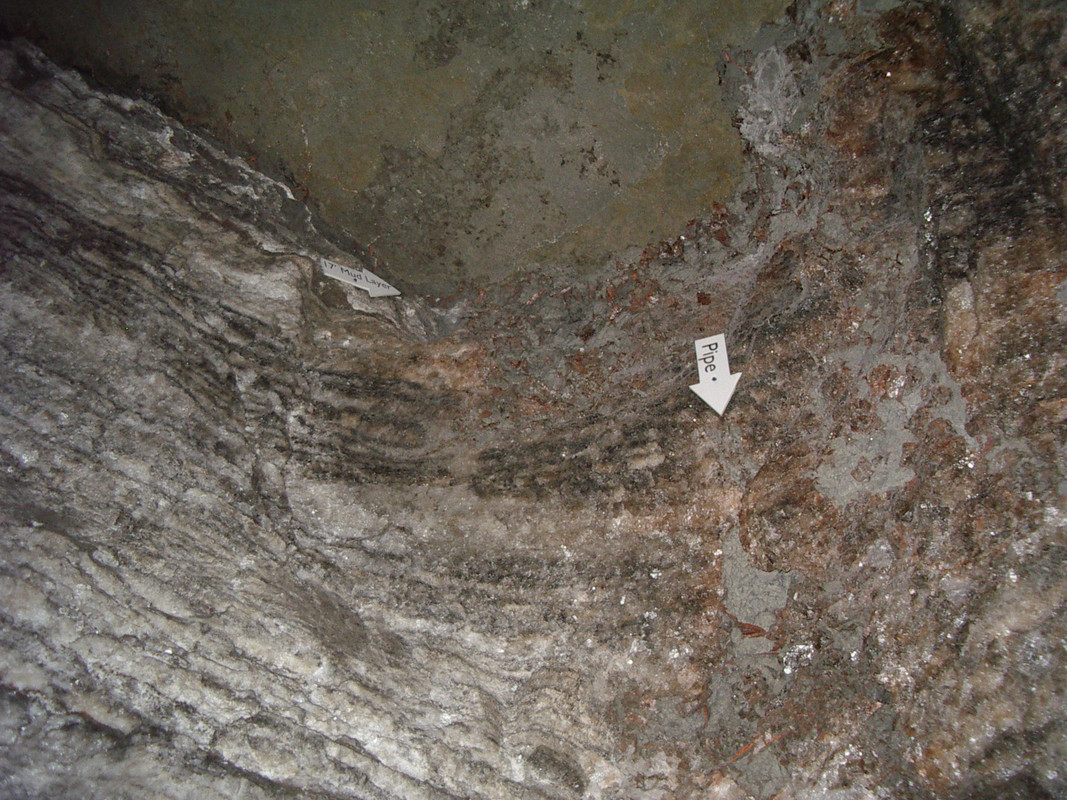 The wall of a salt mine with a white arrow ponting down labeled "Pipe"