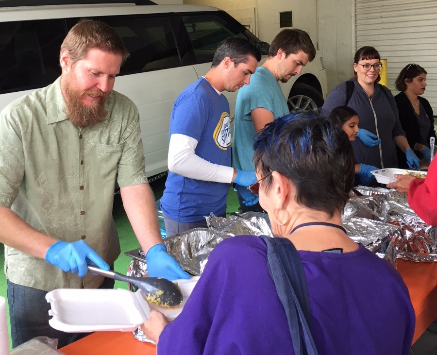 StaxUP Storage Team Members and StratProp Management, Inc, Team Members work together to serve meals to people most in need of them.