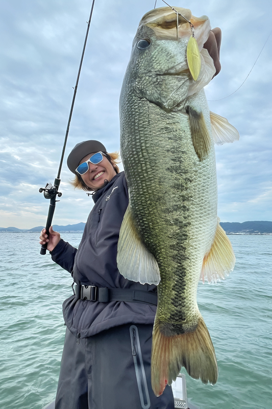 Erica with two bass from murky water