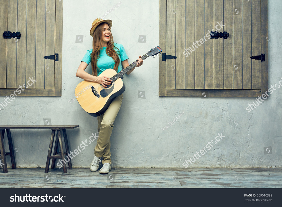 stock-photo-young-woman-playing-acoustic-guitar-full-body-portra
