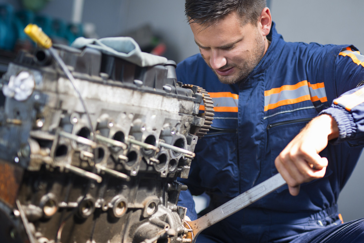 professional-car-mechanic-repairing-automobile-engine-using-wrench-work-shop-1.jpg