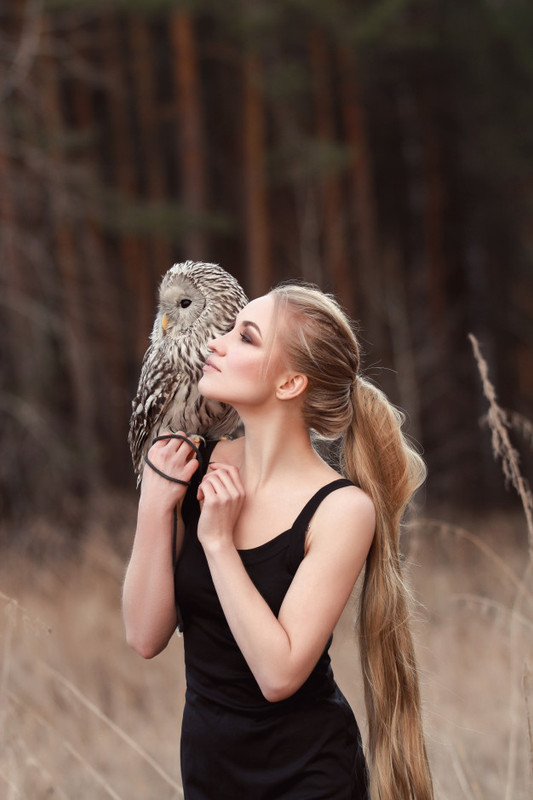 blonde-woman-with-owl-her-hands-walks-woods-autumn-spring-91497-2021.jpg