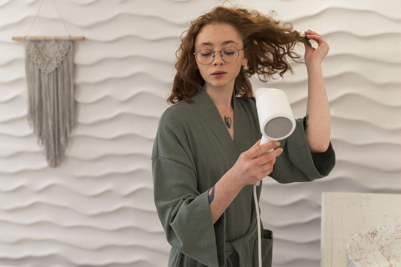 woman using hairdryer her beauty routine (2)
