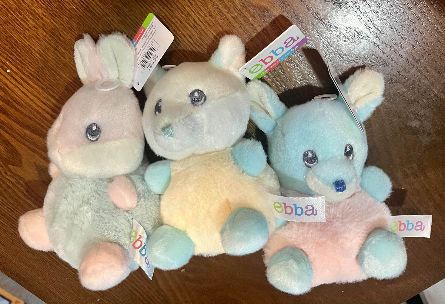 Three small stuffed animals of a rabbit, a fox, and a deer