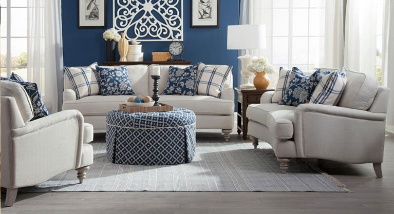 Cottage charm is evoked by the updated details of the Christi Sofa from Magnussen Home. It features a concave shaped front, English arms and turned spool legs. Upholstered in a cream colored chenille fabric, enlivened with plaid and jacquard accent pillows, Christi beckons comfort