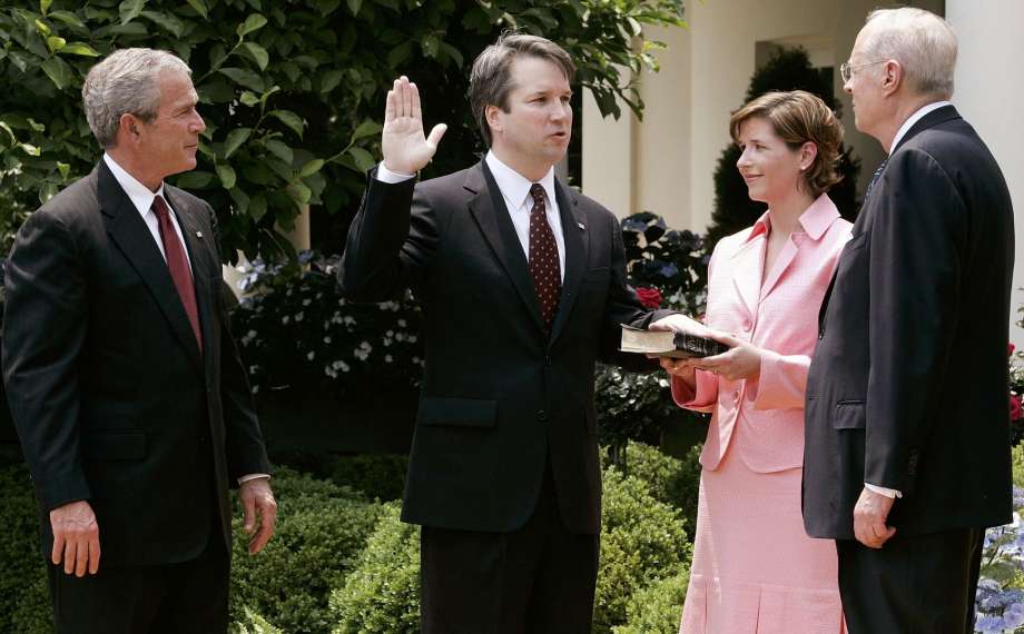 Kavanaugh being sworn in by Justice Anthony Kennedy as President George W. Bush and Kavanaugh's wife, Ashley Estes Kavanaugh, look on