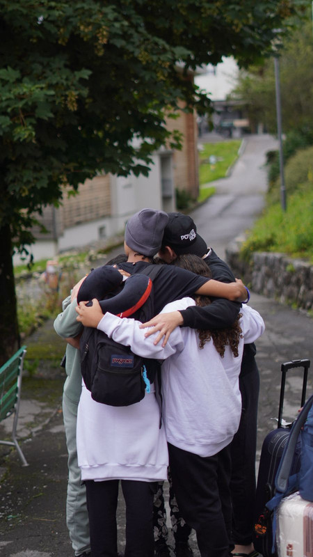 A shy kid is talking in public in autumn camp of frilingue