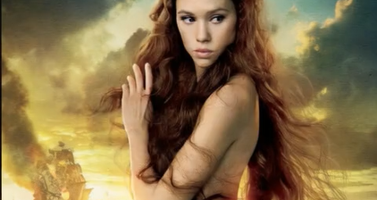 A naked girl who is showing her boobs and pussy (completely nude).