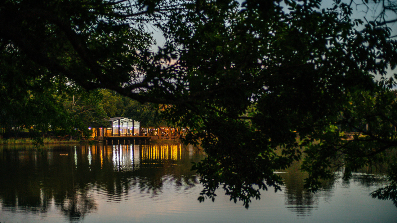A beautiful wedding reception setup at Arch & Arrow, with elegantly decorated tables under a canopy of lights.