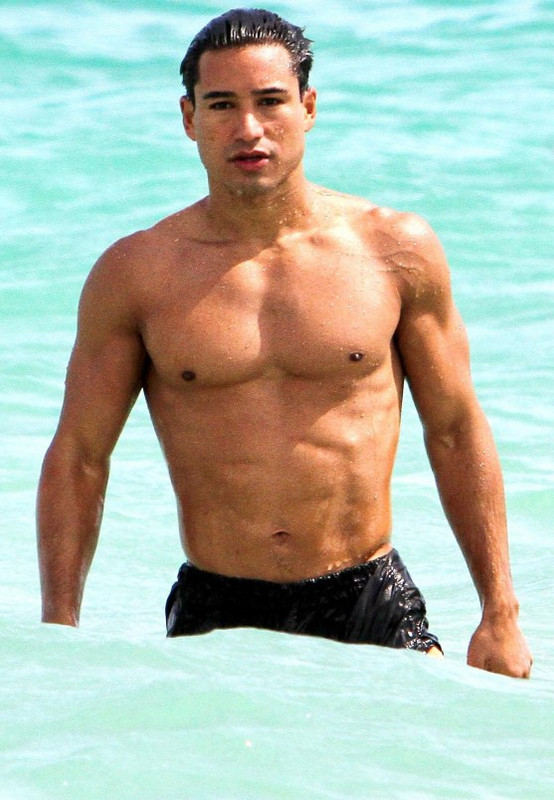 The Libra with shirtless muscular body on the beach
