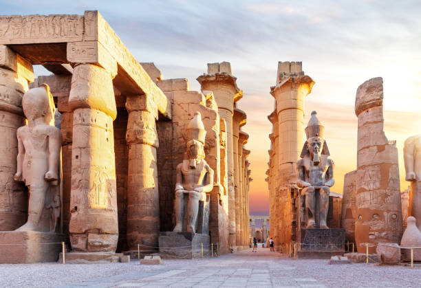 Obelisk of Ramesses II at the entrance to Luxor Temple, with seated colossal statues