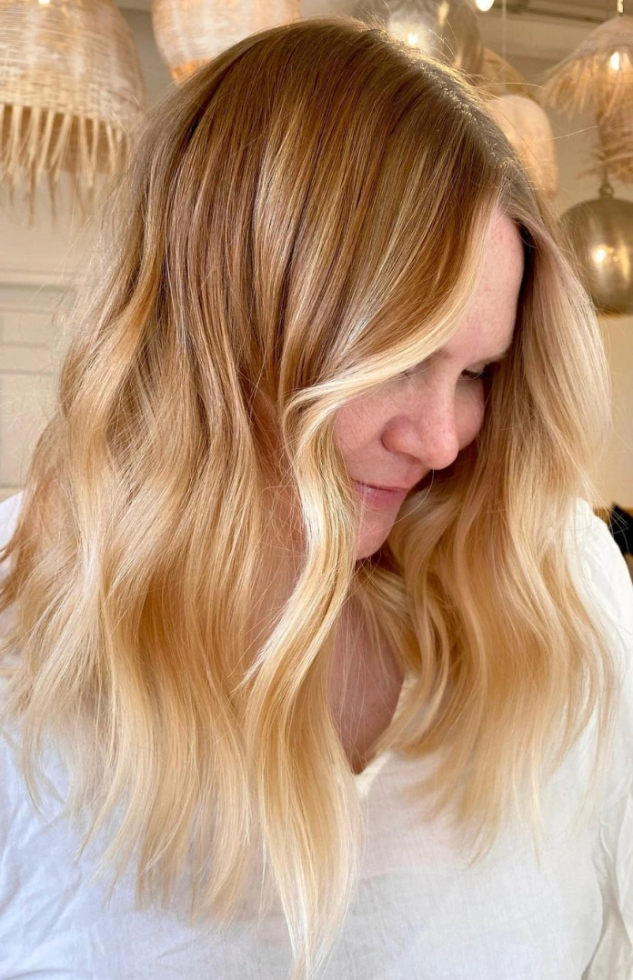 Golden honey blonde hair with a red base