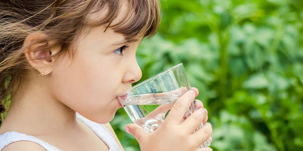 Kid drinking water from a cup