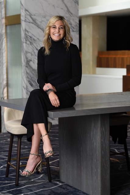 A woman sitting on a wooden bench