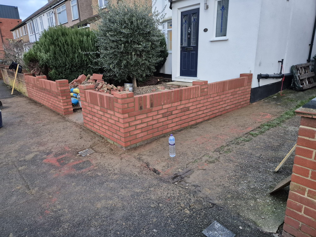 Brick garden wall with decorative coping