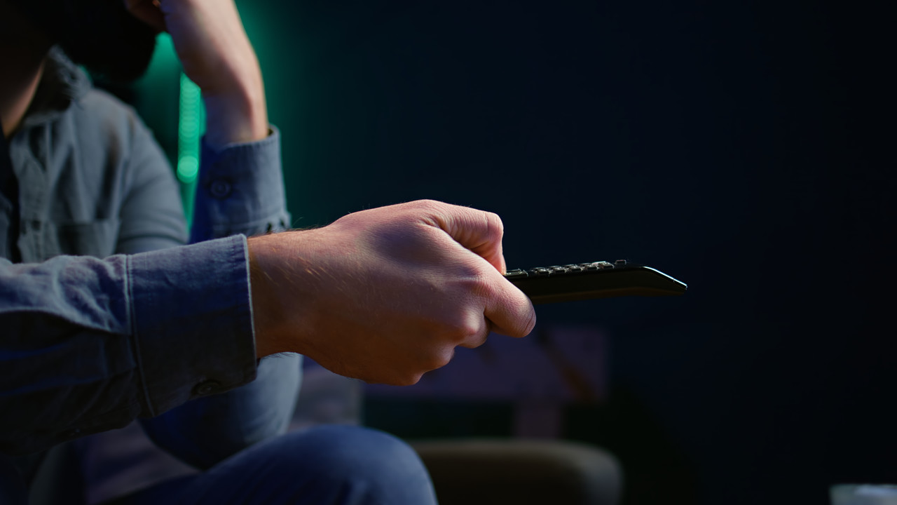 close-up-man-couch-using-remote-control.jpg