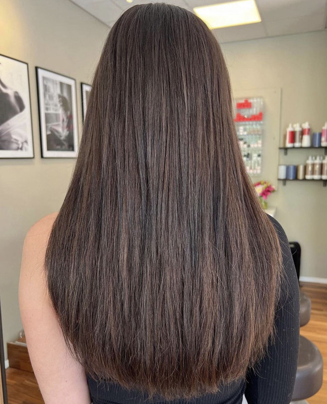 A girl with brown hair and extensions