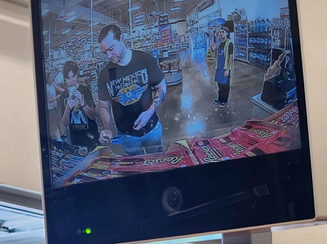 Mel and Seth taking a selfie at self-checkout security cam