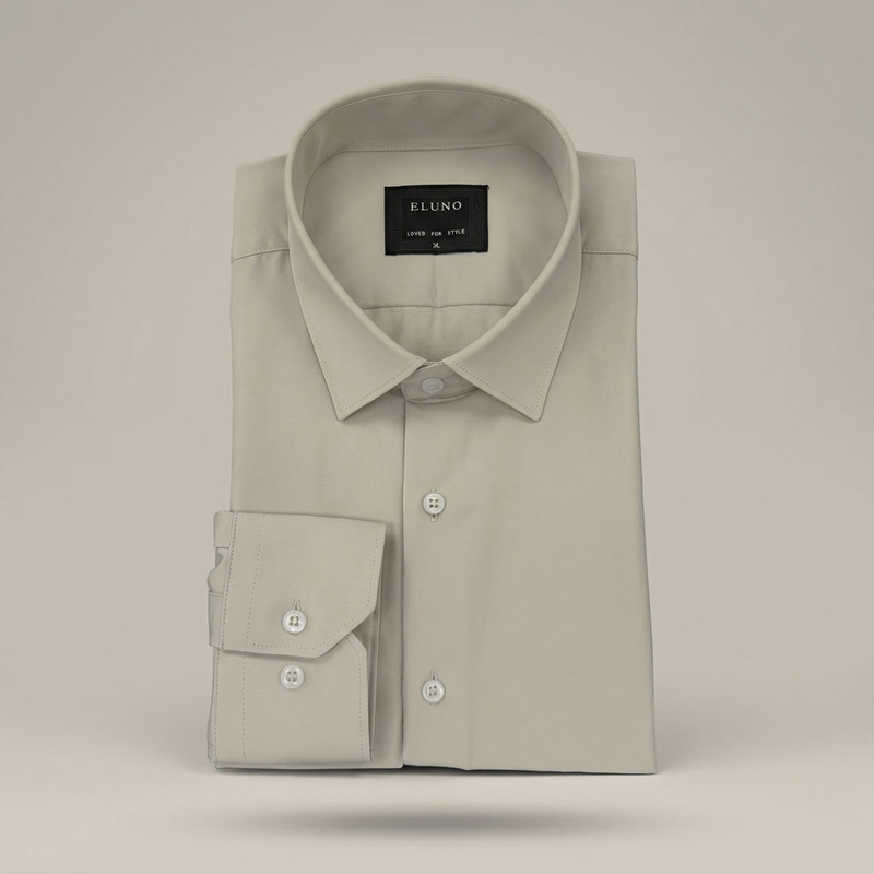 Light blue classic Oxford button-down shirt neatly folded on marble surface