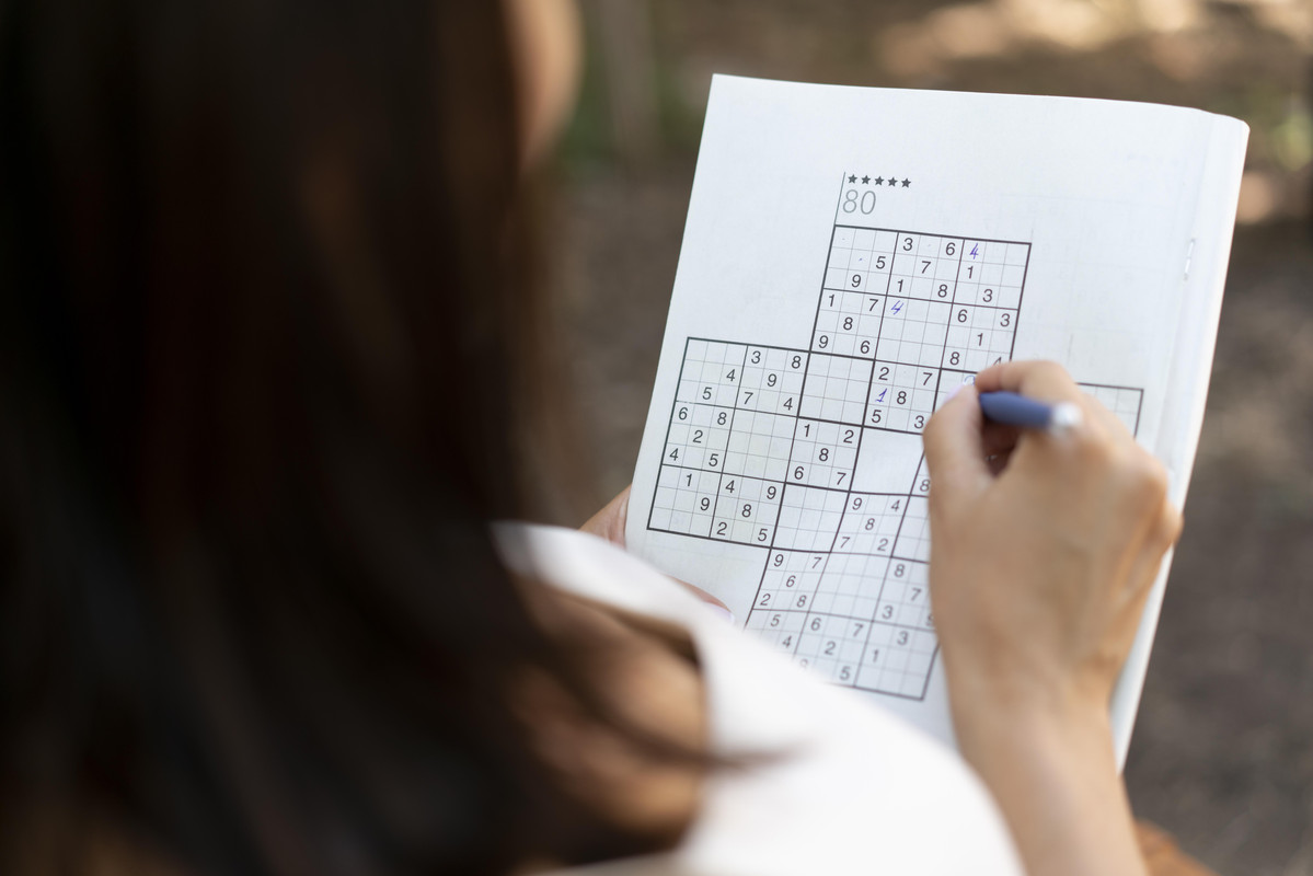 woman-enjoying-sudoku-game-paper-by-herself.jpg