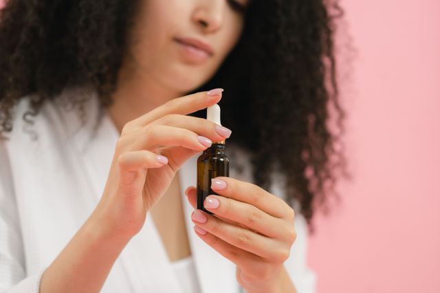 a woman using serum as second beginner skincare products