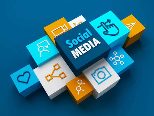 Social media strategist reviewing content on a phone and laptop