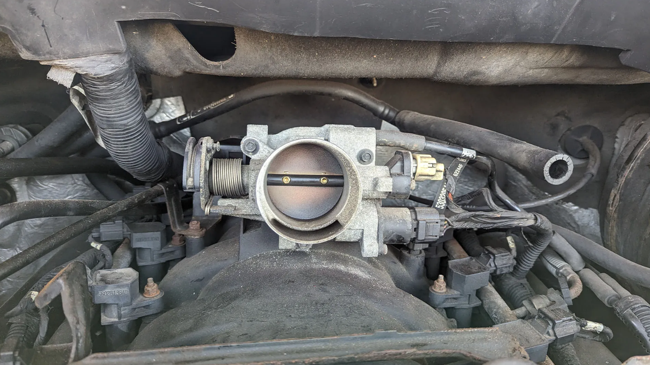 Throttle body in car engine bay