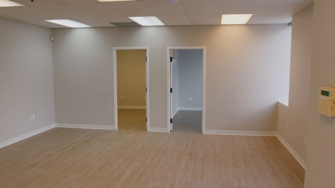 Finished open office with new vinyl plank flooring and doors to private offices