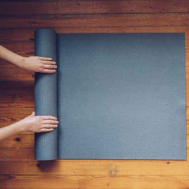 Woman-Rolling-Mat-after-Yoga