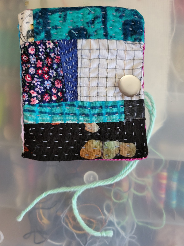The front of a small handmade needlebook